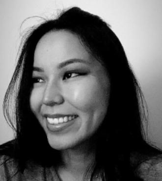 Black and white headshot of smiling young Asian woman.