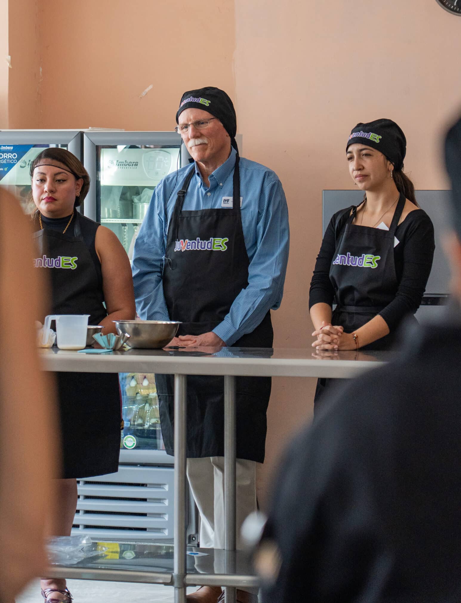 Participants and JuventudES youth take part in a culinary training demonstration to showcase youth workforce development programs.