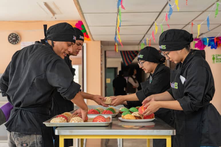Diverse group of young adults active in an IYF youth empowerment program focused on skill building and workforce readiness.