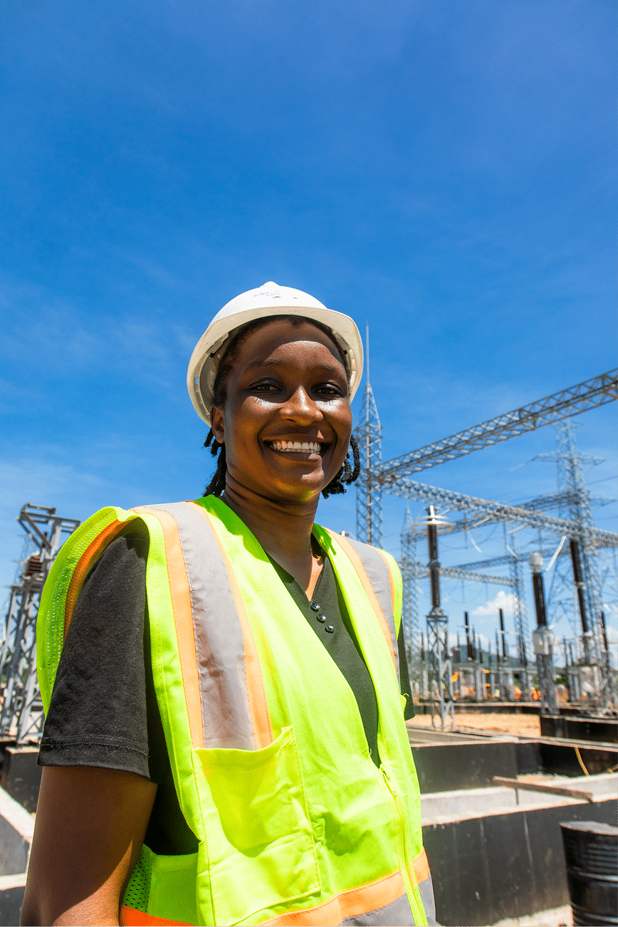 Young person in high-visibility vest and hardhat