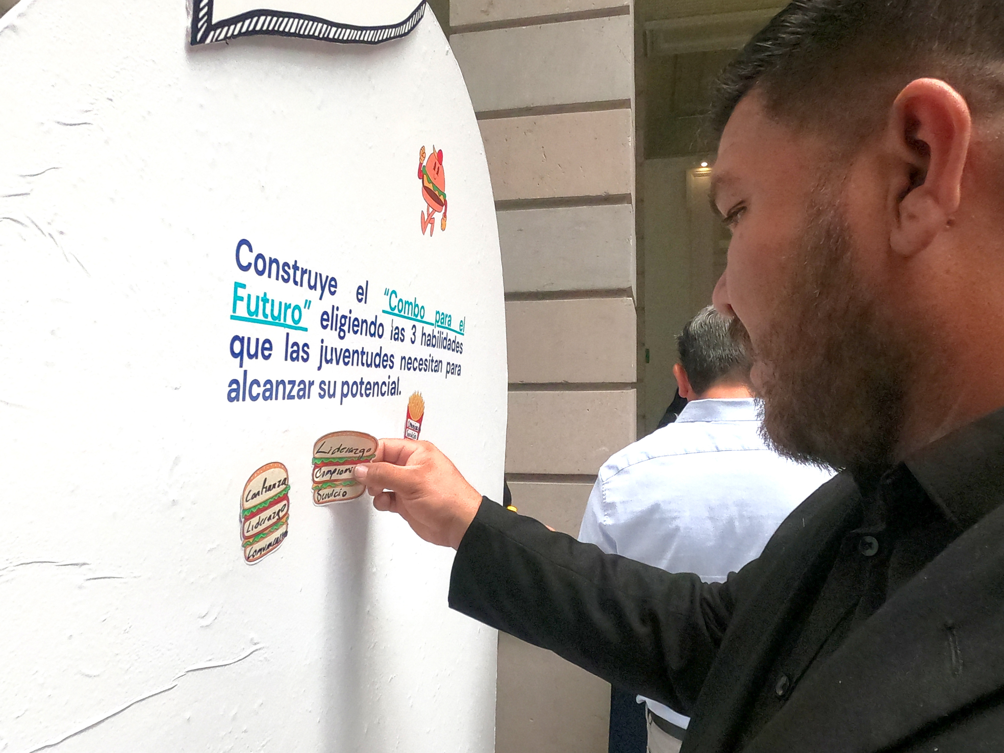 Student writing on a poster