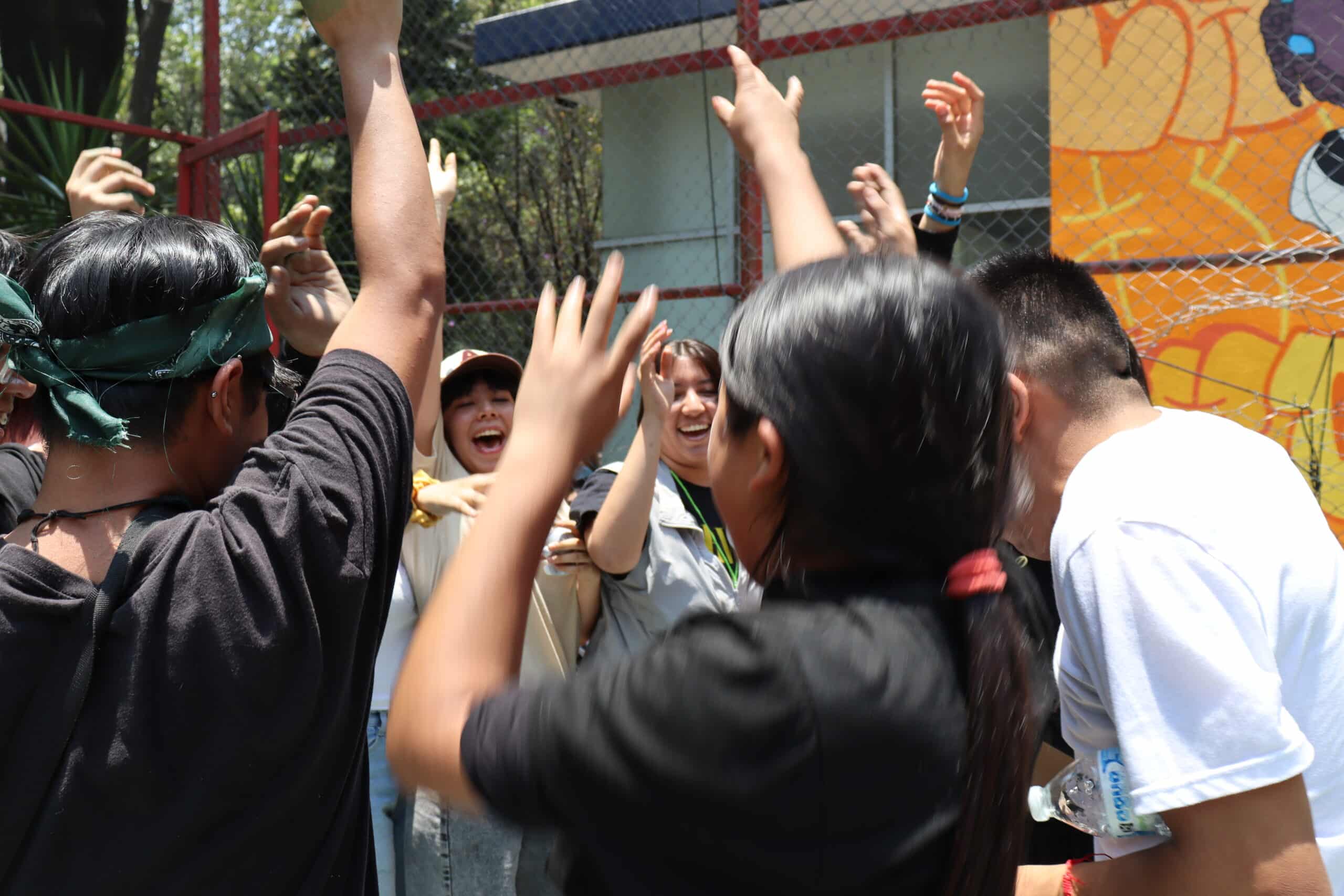 A group of students outside of a school. 