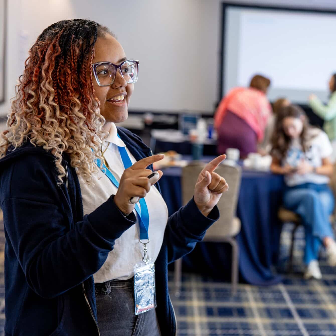 Student writing on a poster